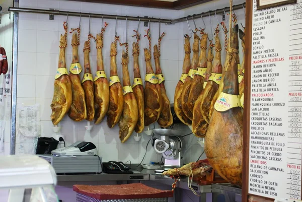 Legs of cured ham (Jamon Serrano) hanging in shop, Rute.