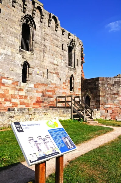 View of the Gothic Revival castle ruin with an information board in the foreground, Stafford.