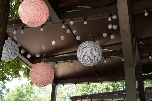 Paper chandelier on street restaurant
