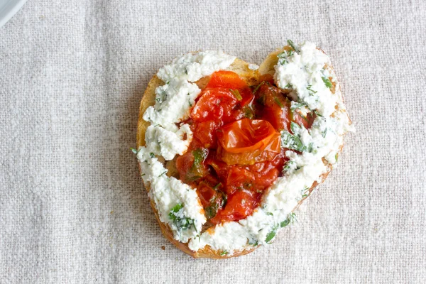 Bruschetta with ricotta cheese and tomato sauce form of heart