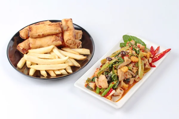 Chinese Vegetable festival  food as fried basil with mixed vegetables served deep fried spring roll and French fries .