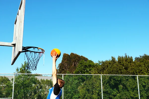Two handed basketball dunk