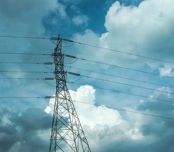 Electrical poles of high voltage in white cloud and blue sky.