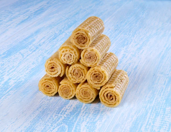 Wafer rolls on a wooden blue background