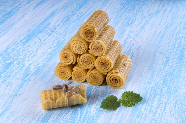 Wafer rolls on a wooden blue background