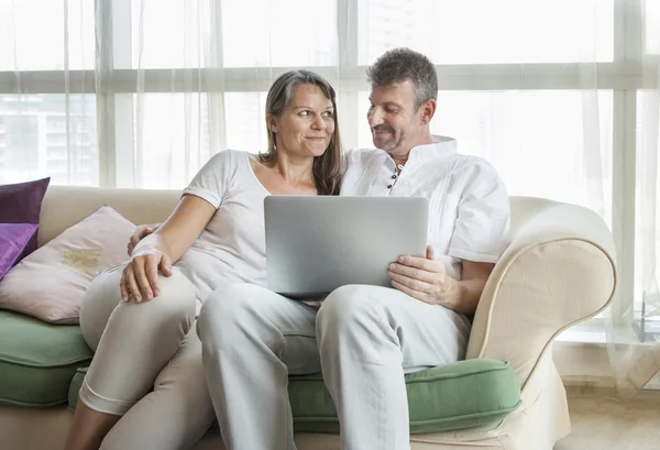 Middle aged couple with a computer