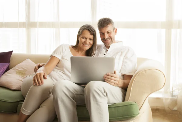 Middle aged couple with a computer