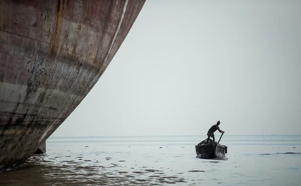 man rowing a small boat