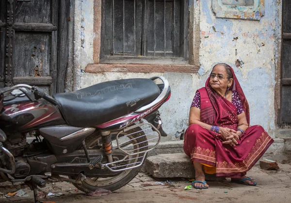 Old lady outside her home