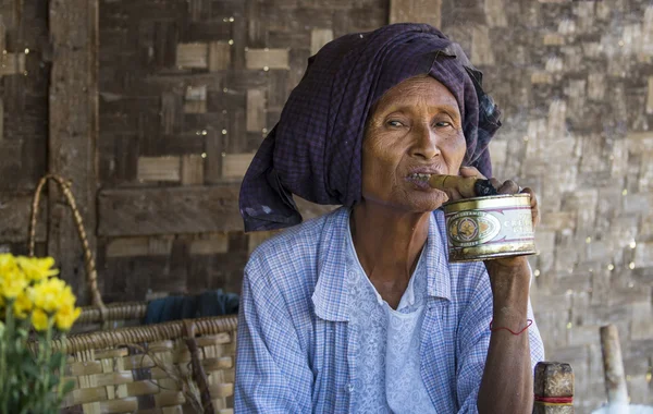 Old woman smoking a cigar