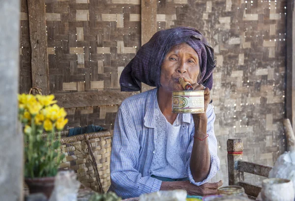 Old woman smoking a cigar