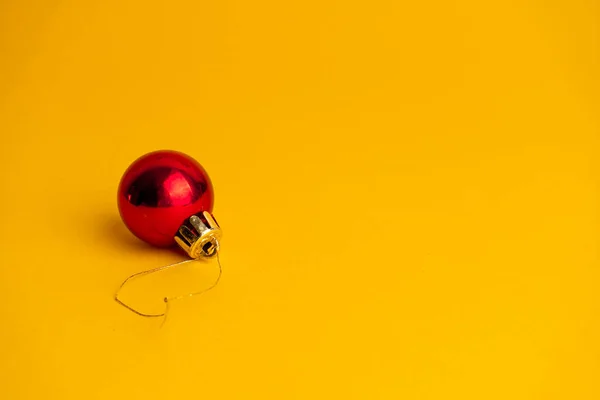 Red Ball Decoration Christmas Tree Yellow Background Copy Space — Stock Photo, Image