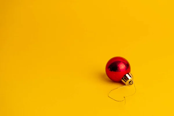 Red Ball Decoration Christmas Tree Yellow Background Copy Space — Stock Photo, Image