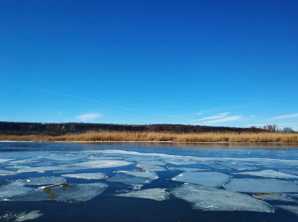 Ice floes float on the river. Thaw at the end of winter.