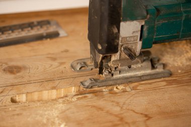 Ahşap işleme. Tahta tahtayı elektrikli testereyle kesen kişi.