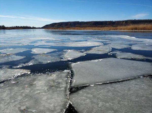 Ice floes float on the river. Thaw at the end of winter.