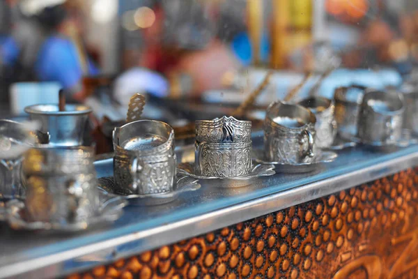 Street counter selling coffee in Turkey. Set of Turkish coffee cups on the showcase.