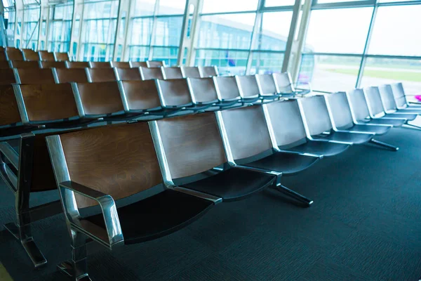 Deserted airport terminal. Rows of empty seats in the waiting room.