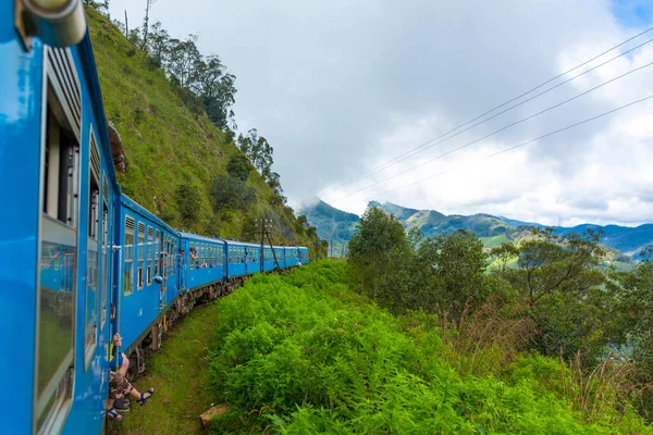 Travel by public train around the island of Sri Lanka. The train travels through mountains and tea plantations. Scenic railway.