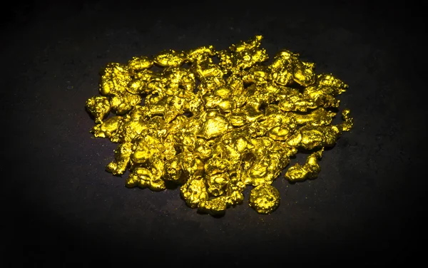 Real golden nuggets isolated on black background. — Stock Photo, Image