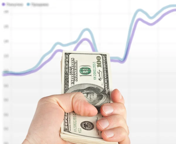 Money in the hands near the graph — Stock Photo, Image