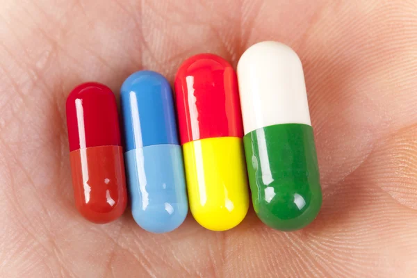 Capsule pills lies on the hand — Stock Photo, Image