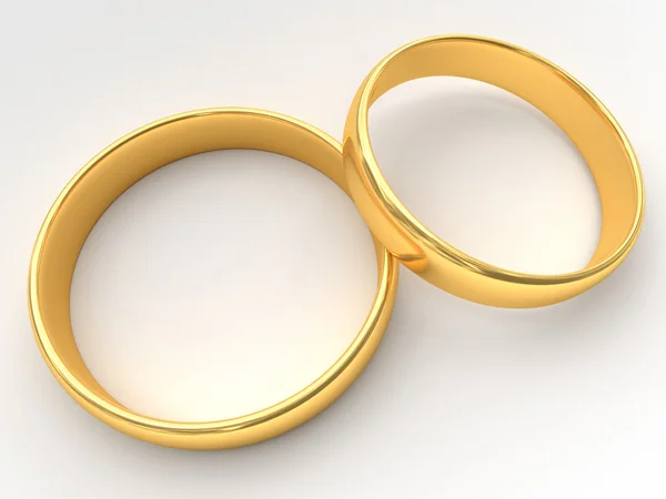 Goldene Eheringe liegen aufeinander — Stockfoto