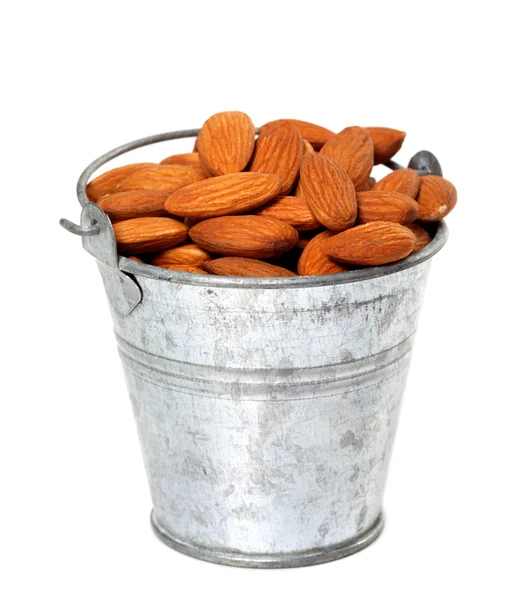 Old tin bucket with almonds — Stock Photo, Image