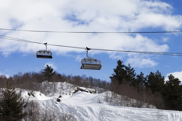 Chair-lift and off-piste slope in ski resort — Stock Photo, Image