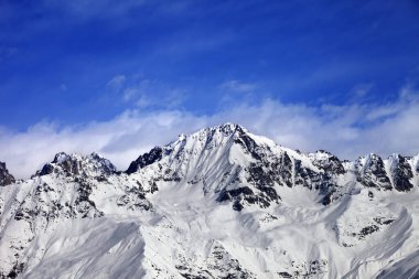 Snow mountains in winter sun day and blue sky with clouds. View from ski lift on Hatsvali, Svaneti region of Georgia. Caucasus Mountains. 