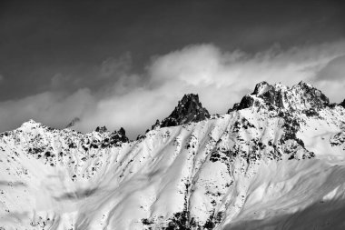 Black and white snow avalanches mountainside in clouds. View from ski lift on Hatsvali, Svaneti region of Georgia. Caucasus Mountains. 