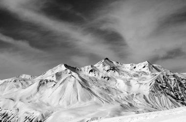 Winter snow mountains in windy day. Caucasus Mountains, Georgia, region Gudauri. Black and white toned landscape.