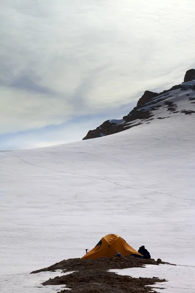 Турист Сидящий Возле Оранжевой Палатки Вечерних Снежных Горах Ночлег Турция — стоковое фото
