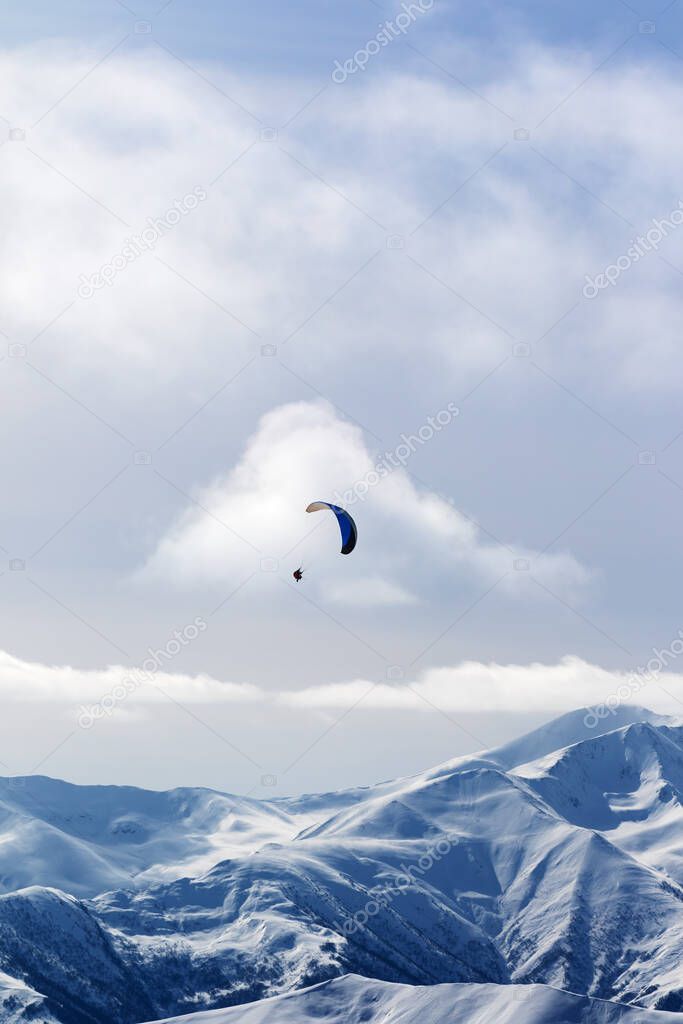 Sky gliding in winter snow mountains at nice sun evening. Caucasus Mountains, Georgia, region Gudauri.