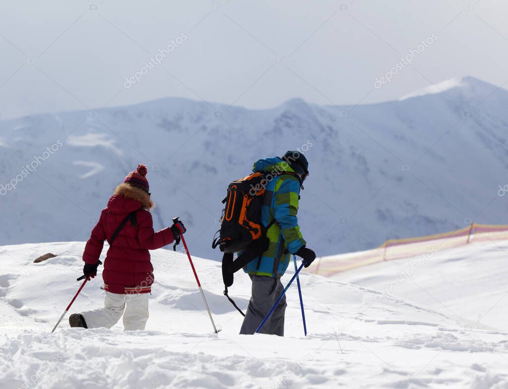 Father and daughter on ski resort after snowfall. Caucasus Mountains in winter, Georgia, region Gudauri.