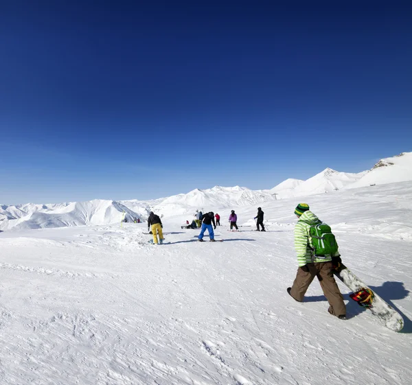 Skiers and snowboarders on ski slope — Stock Photo, Image