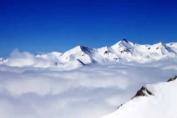 Χειμώνα χιονισμένο βουνά κάτω από τα σύννεφα σε ωραία ημέρα — Φωτογραφία Αρχείου