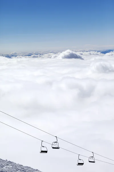 Mountains under clouds and chair-lift — Stock Photo, Image