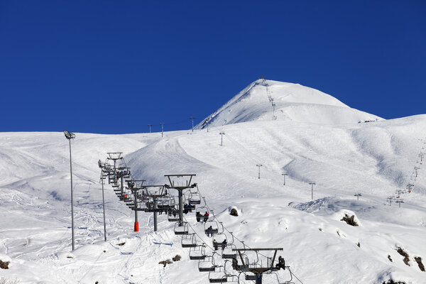 Winter mountains and ski slope at nice sun day