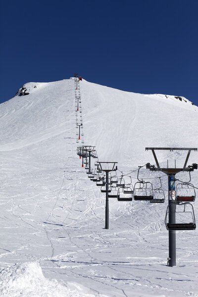 Winter mountains and ski slope at nice day