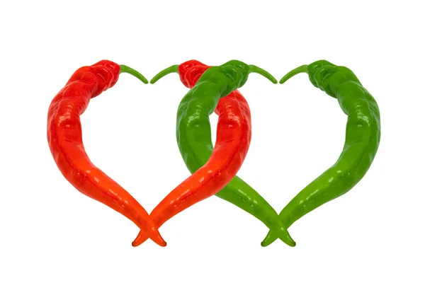 Red and green chili peppers in love. Hearts composed of peppers. — Stock Photo, Image