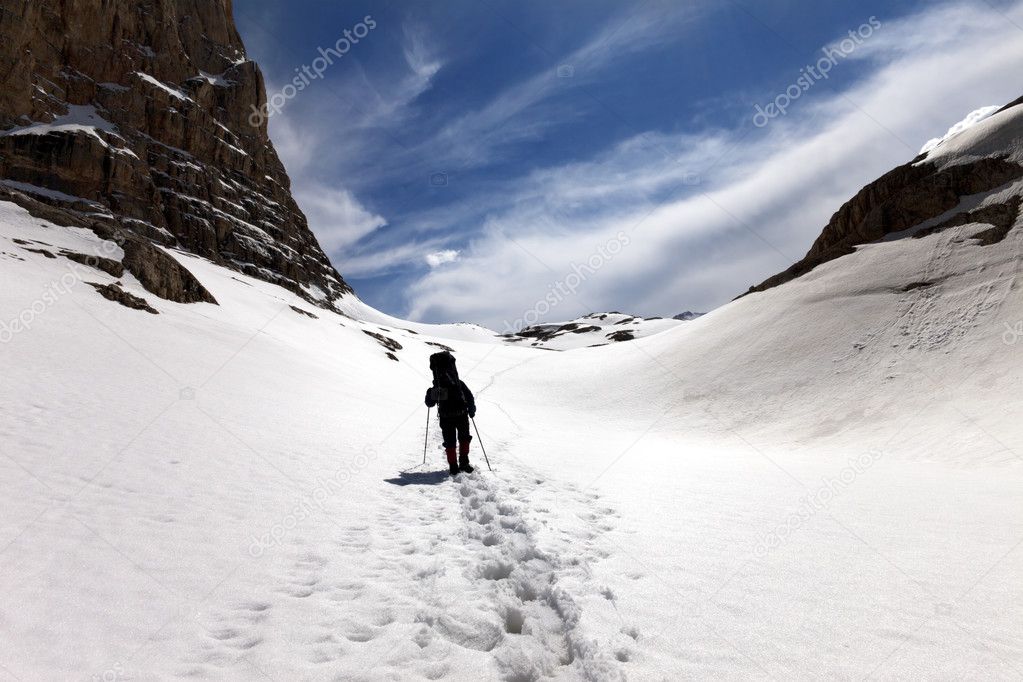 Silhouette of hiker on snow plateau