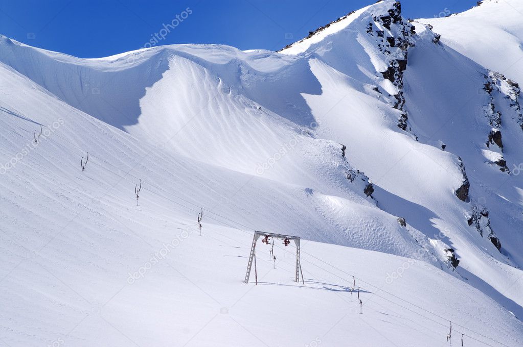 Old surface lift and mountains with snow cornice