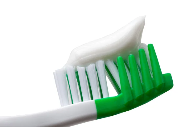 歯磨き粉の白い背景で隔離の緑の歯ブラシ — ストック写真