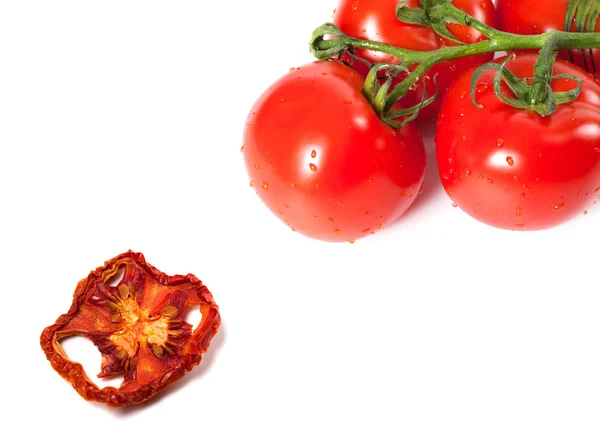 Bunch of raw tomatoes with water drops and dried slice