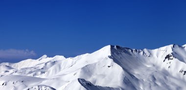 Güneşli bir gün, devreden karlı yamaç panoramik görünüm