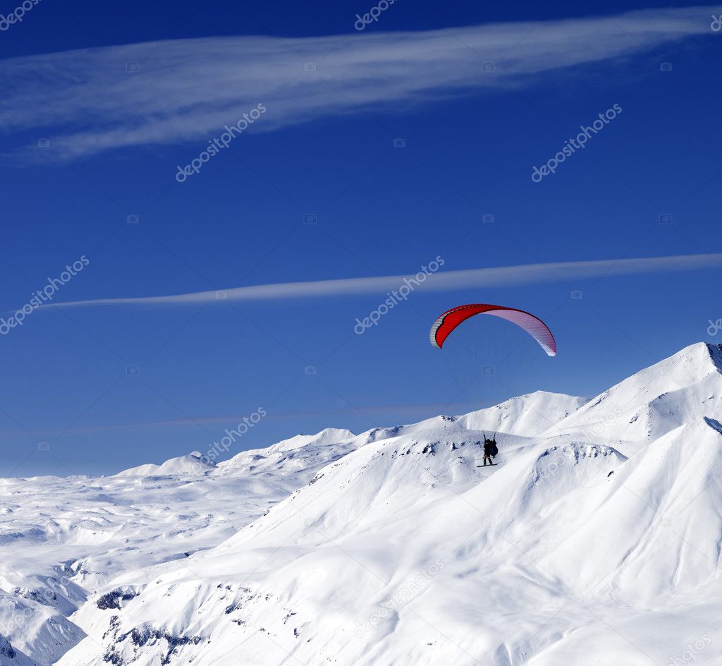 Sky gliding in snowy mountains at nice sun day