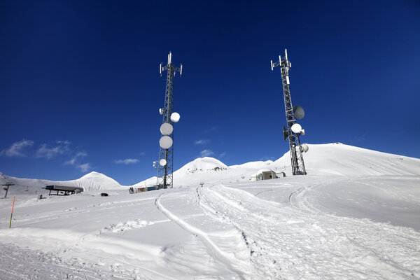 Ratrac ski road and satellite dishes at nice sun day