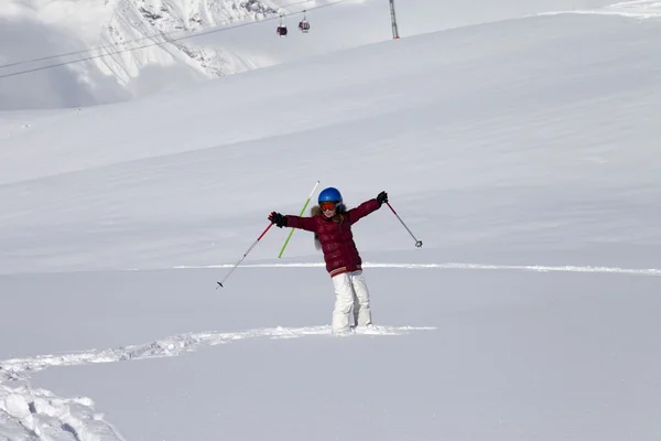 Happy girl on off-piste slope with new fallen snow at nice sun d Stock Picture