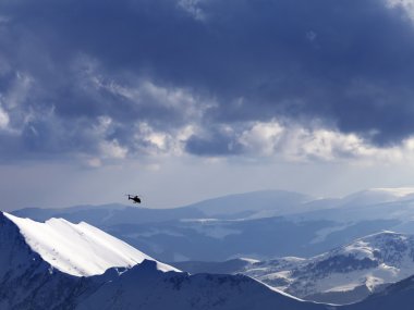 Off-piste slope for heliskiing and helicopter in evening clipart